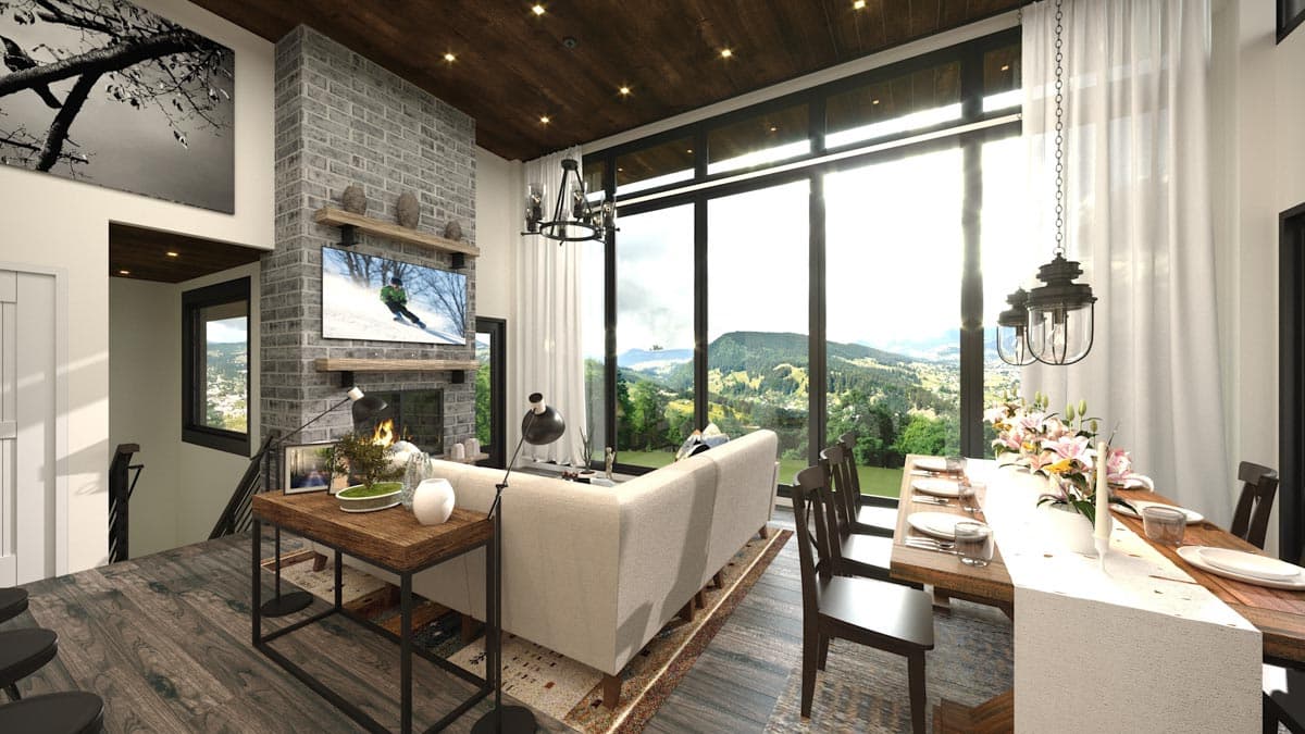 Interior rendering of a living and dining area with a stone fireplace, sectional sofa, large windows, and mountain views.