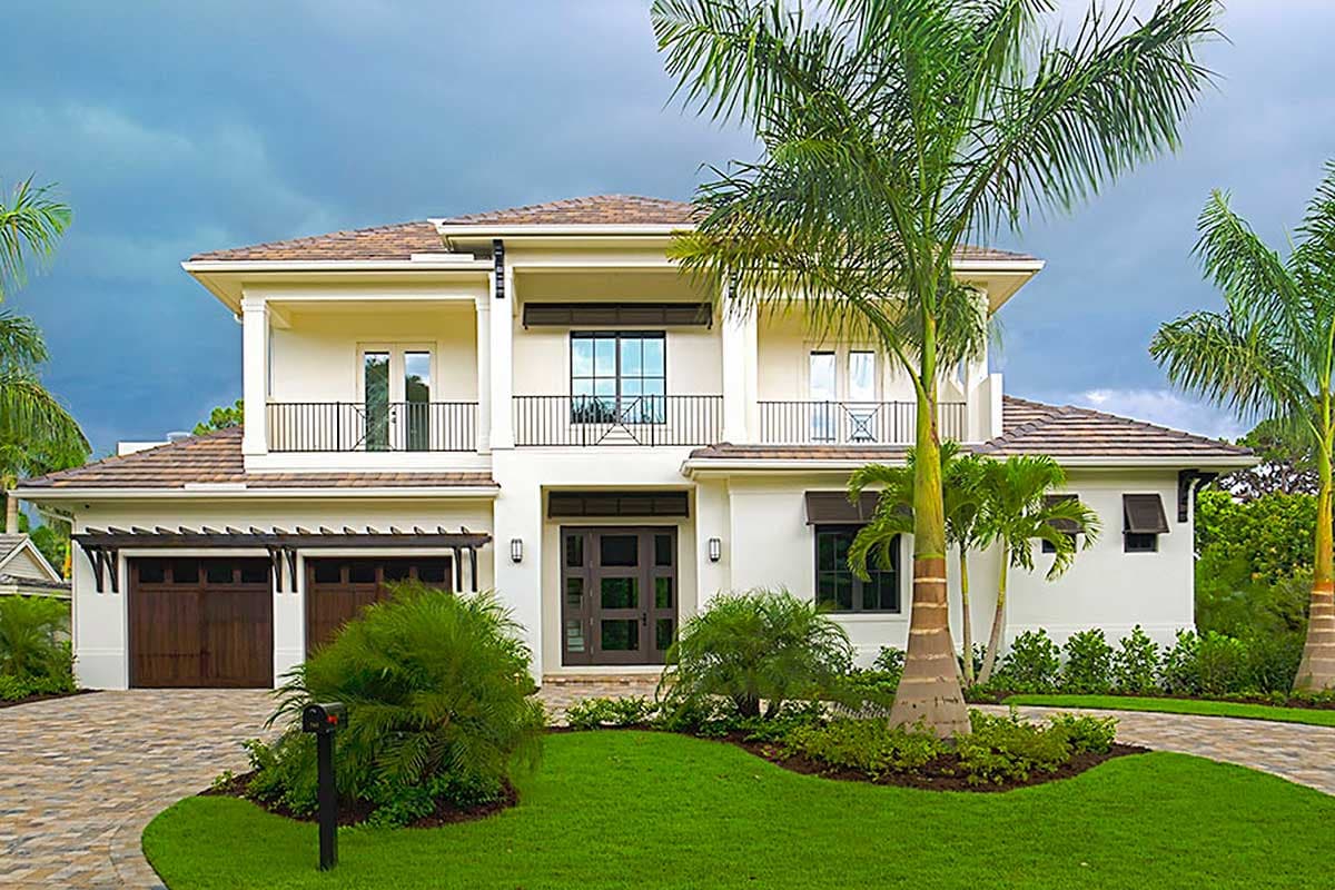 House plan exterior with two stories, a Mediterranean style, balcony, pergola-covered garage, and dark-framed windows.