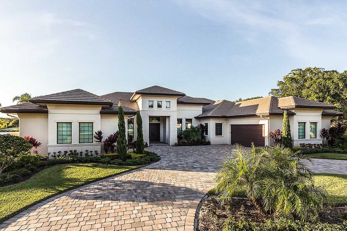 House plan exterior: Modern style, one-story residence with tile roof, entry portico, and attached garage.