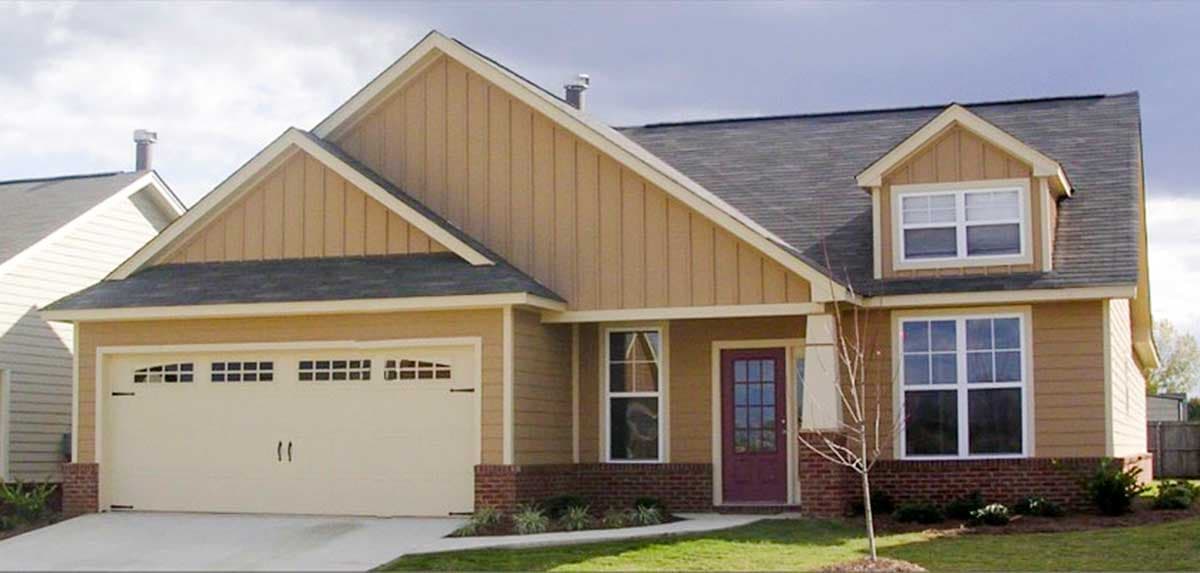 House plan exterior: One-story Ranch with side-entry garage, gable, dormer, and brick foundation.