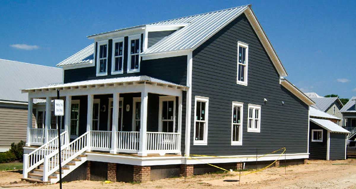 House plan exterior of a two-story Modern Farmhouse with a metal roof, front porch, and multiple gables.