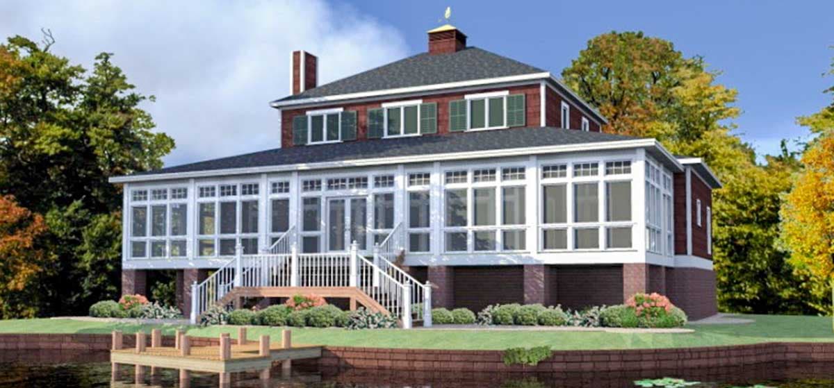 House plan exterior: two-story home with wraparound sunroom, multiple gables, and brick foundation.