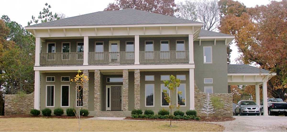 House plan exterior: Two-story home with covered balcony, stone-clad columns, and attached carport.