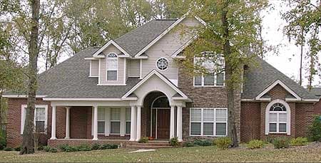 House plan exterior of a two-story home with a covered porch, arched entry, brick facade, and varied rooflines.