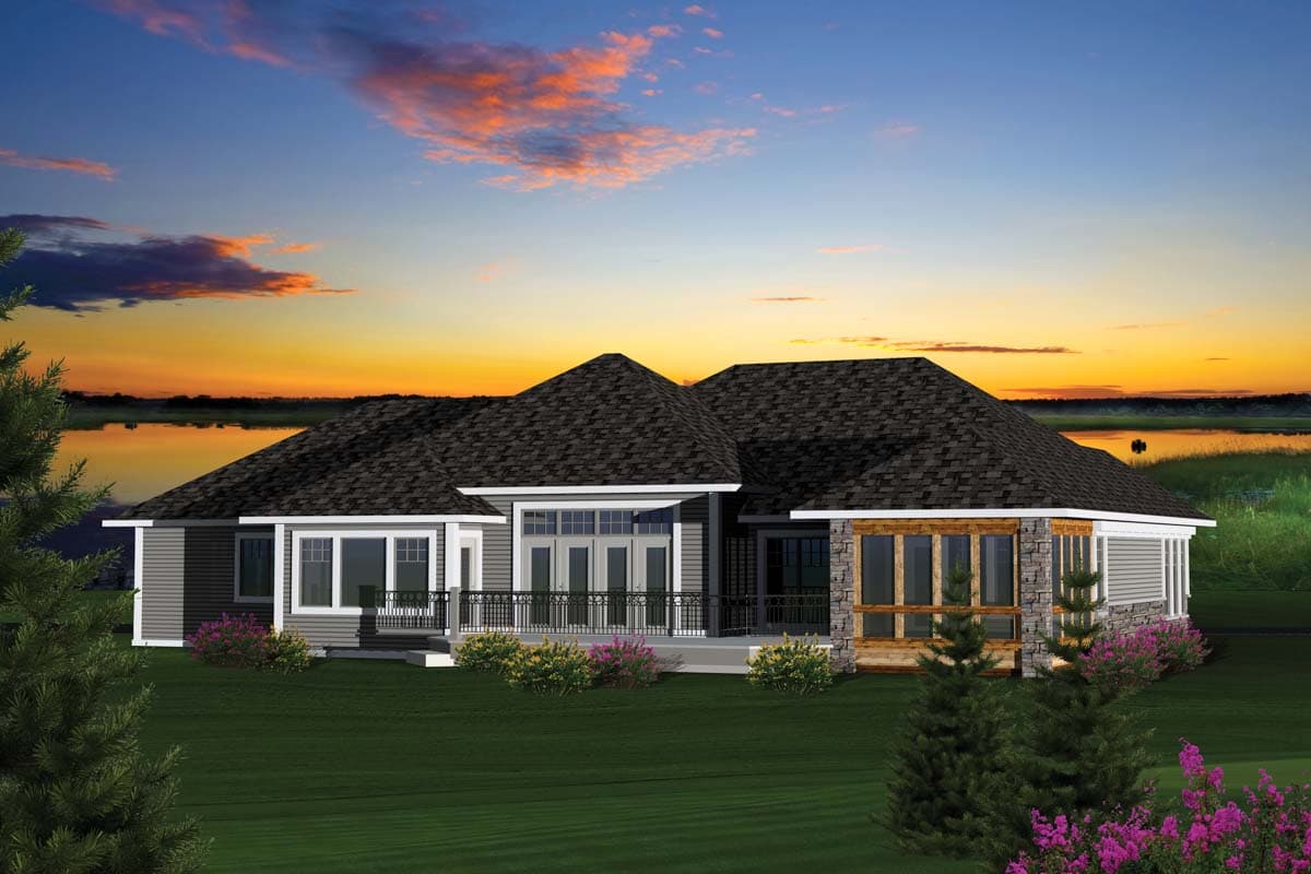 House plan exterior: One-story modern home with a wraparound deck, stone accents, and multiple gables.
