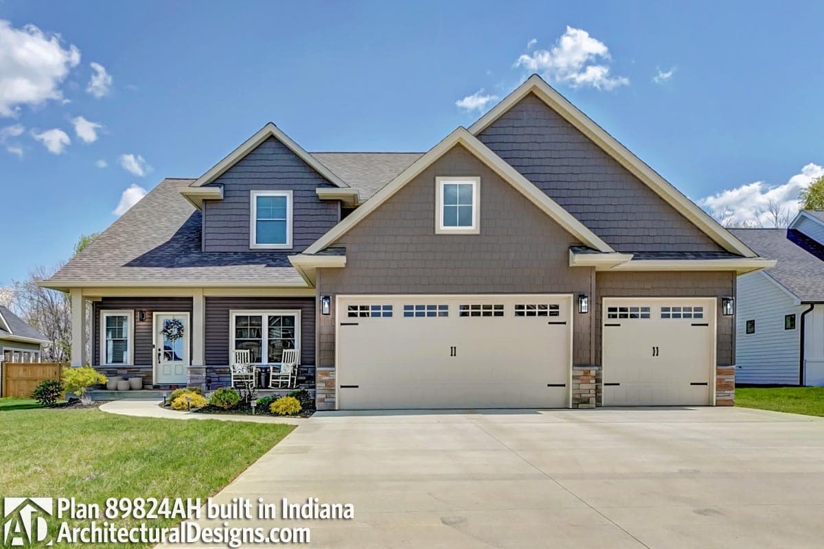 House plan exterior: two-story Modern Farmhouse with gable roof, front porch, and a three-car garage.