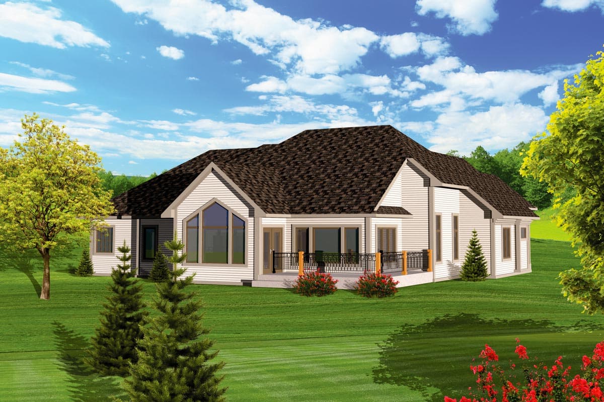 House plan exterior: One-story home with a hip roof, gabled dormers, and a rear deck with decorative railings.