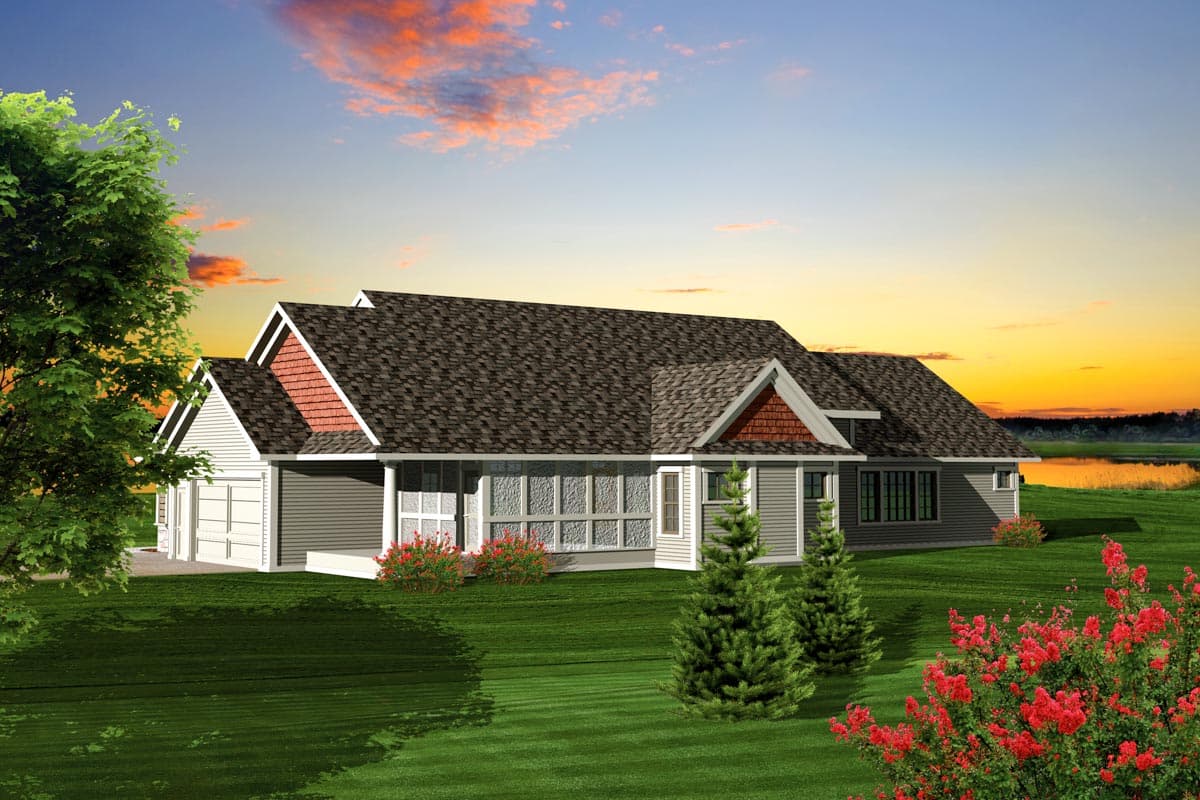 House plan exterior: Ranch style, one story, with gabled rooflines, prominent dormers, covered front porch, and attached two-car garage.