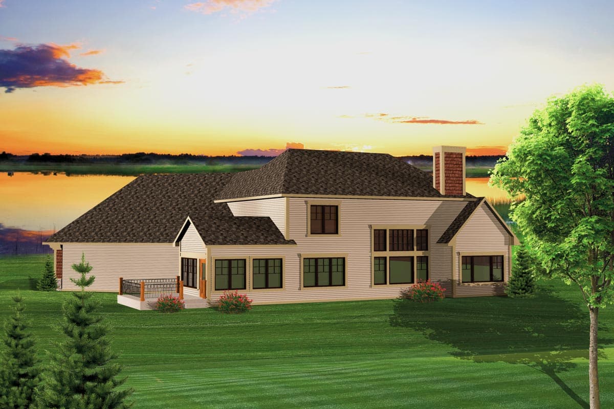 House plan exterior of a two-story home with multiple gables, large windows, a brick chimney, and a deck.