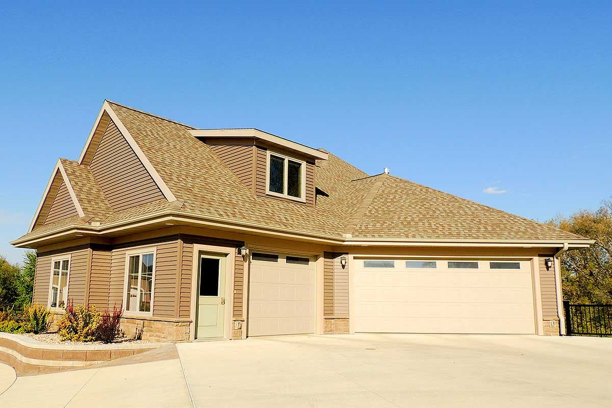 House plan exterior: Traditional style, two stories, three-car garage, gabled rooflines and dormer.