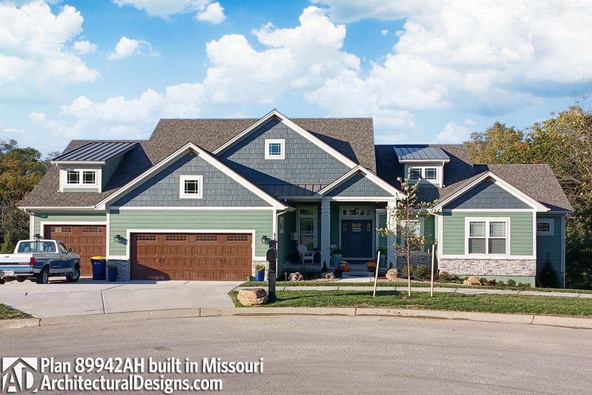 House plan exterior: Two-story Modern Farmhouse with three-car garage, dormers, gables, and stone accents.
