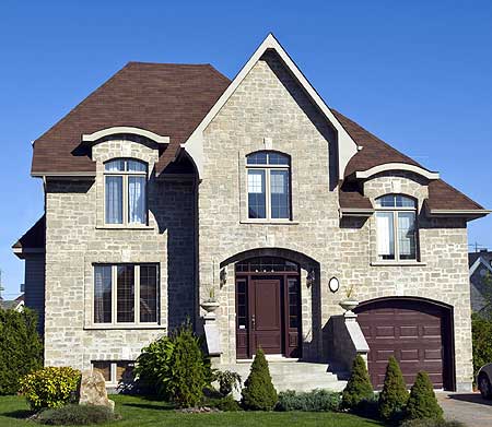 Two-story house plan exterior with stone facade, prominent gables, arched entryway, and attached garage.