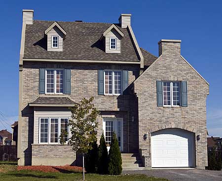 Two-story house plan exterior with brick facade, dormers, gable roof, and attached garage with arched entrance.