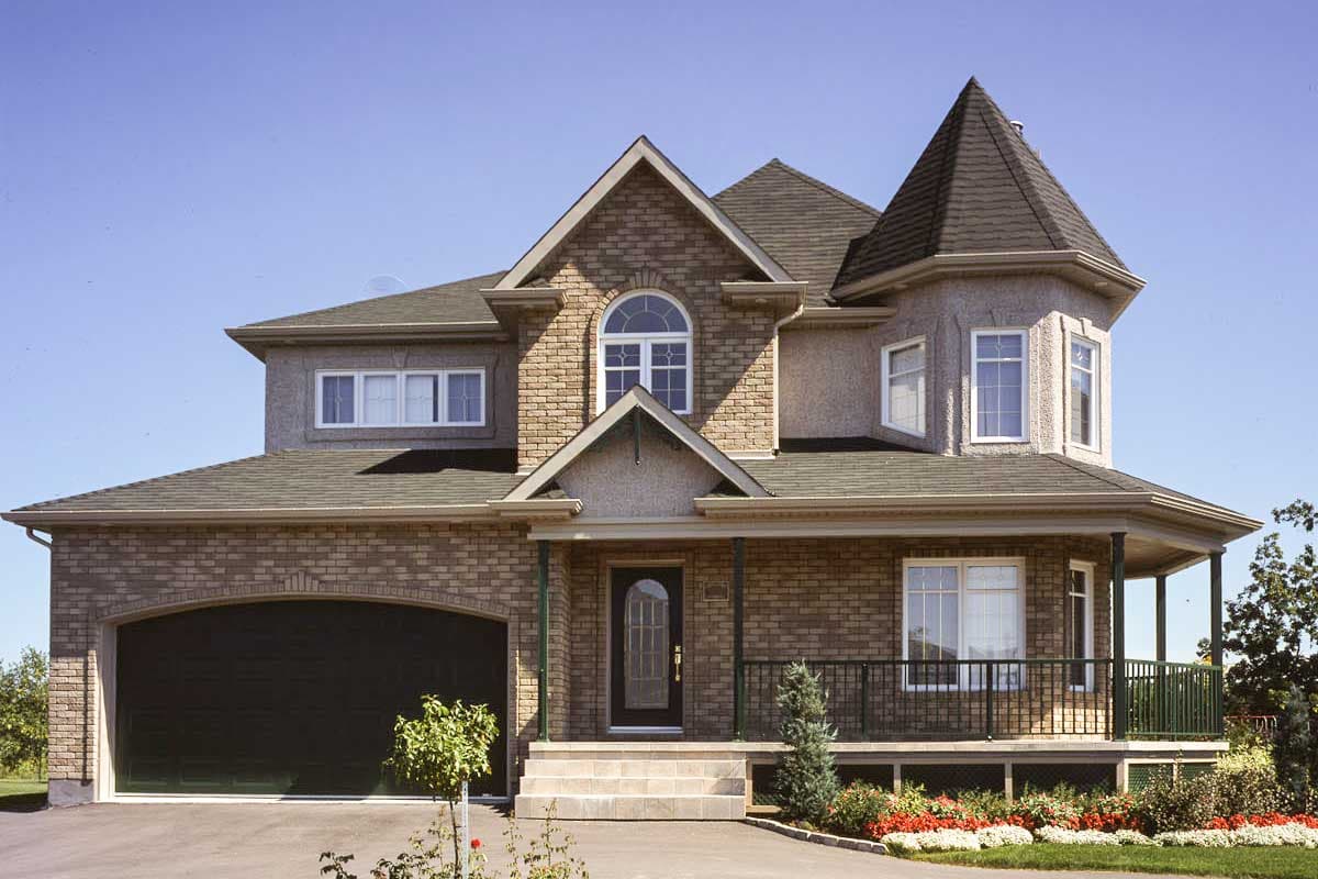 House plan exterior with brick facade, arched garage, wraparound porch, and turret.