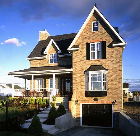 Two-story brick house plan with a covered porch, gabled dormers, bay window, and attached garage.