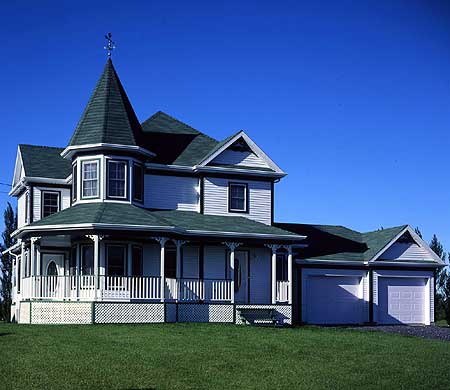 House plan exterior: Two-story Victorian with turret, wrap-around porch, and attached two-car garage.