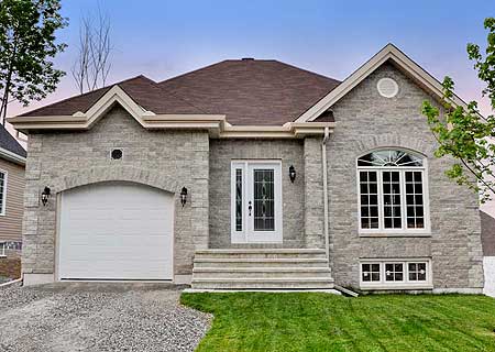 House plan exterior: Single-story modern home with stone facade, attached garage, arched entry, and prominent gable.