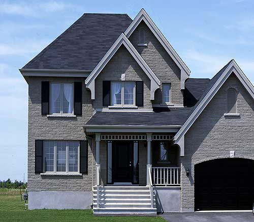 Two-story house plan exterior with a covered porch, multiple gables, dormers, and an attached garage.