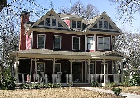 House plan exterior: Two-story Victorian home with wraparound porch, prominent gables, bay window, and brick chimney.