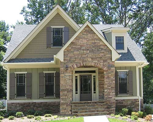Craftsman style house plan exterior with stone accents, prominent gable, dormer window, and covered entry porch.