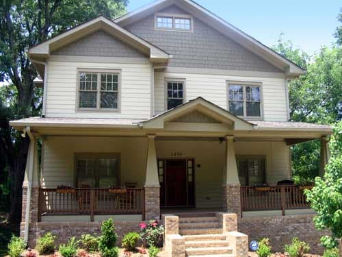 House plan exterior: Two-story home with full-width covered porch, brick base, and multi-pane windows.