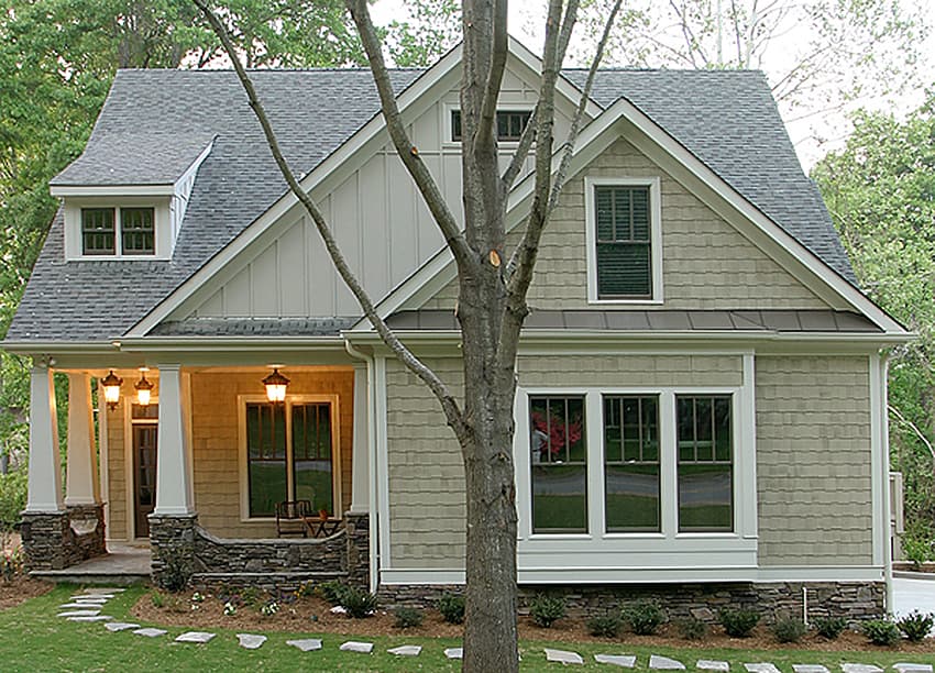 House plan exterior of a two-story home with a covered front porch, multiple gables, dormer window, and stone foundation.