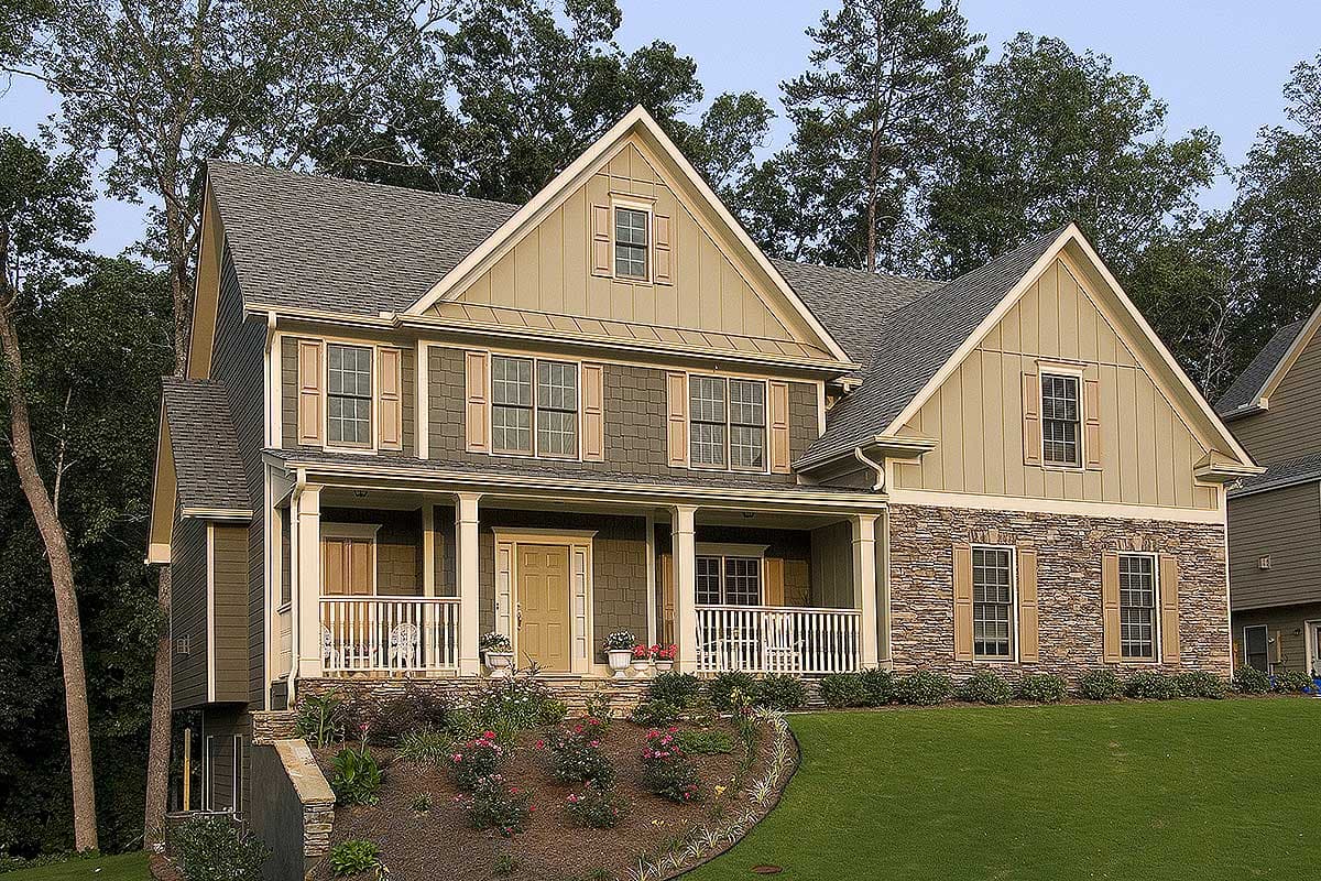 House plan exterior: two-story home with covered front porch, stone accents, multiple gables, and dormer windows.