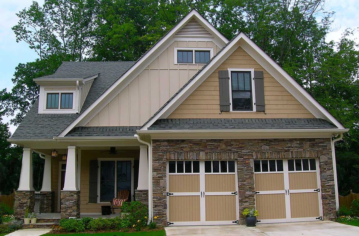 House plan exterior: Two-story Modern Farmhouse with stone accents, gable dormer, and side-entry double garage.