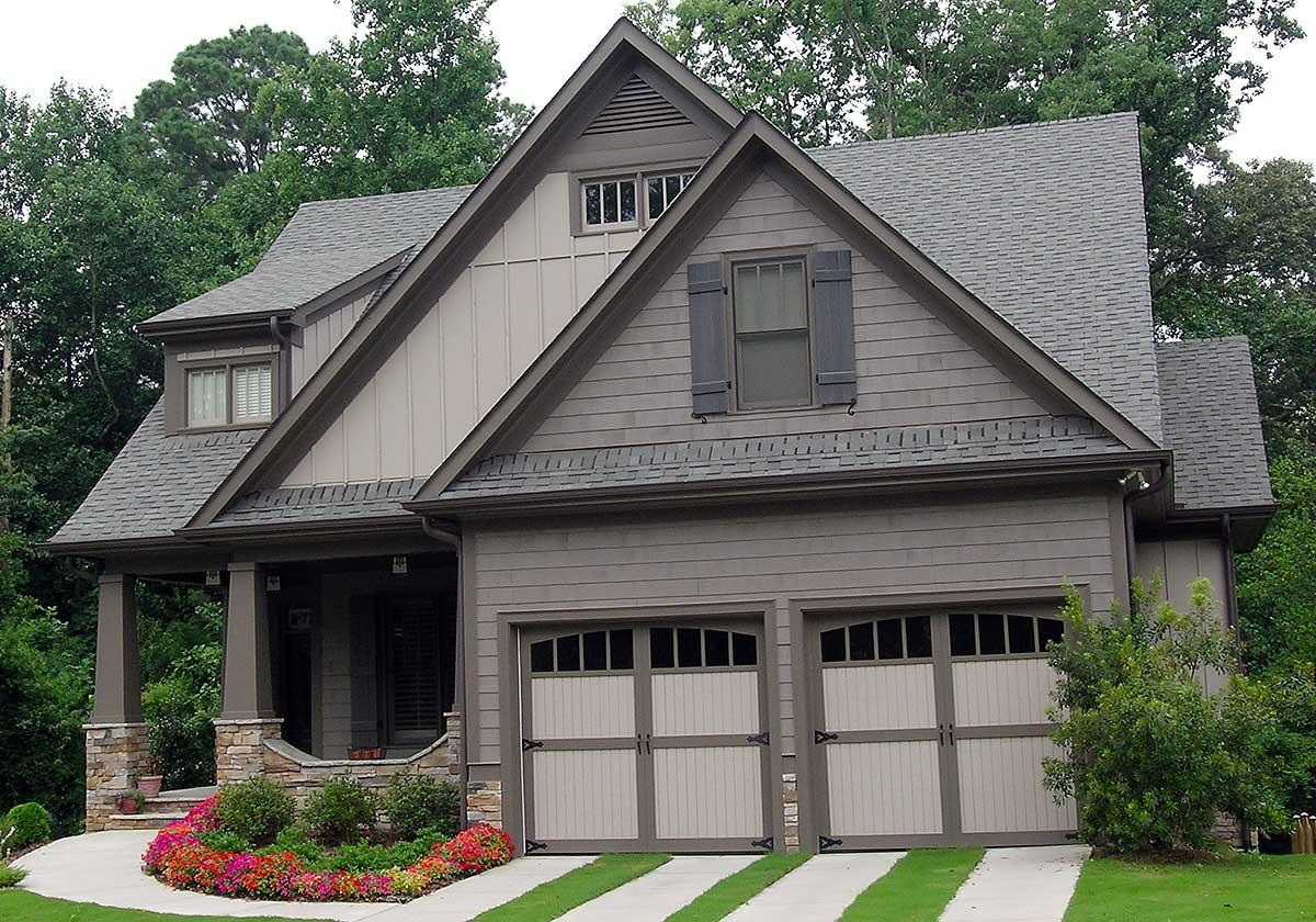 House plan exterior showing a two-story Modern Farmhouse with a covered porch, dual garage doors, and varied rooflines.