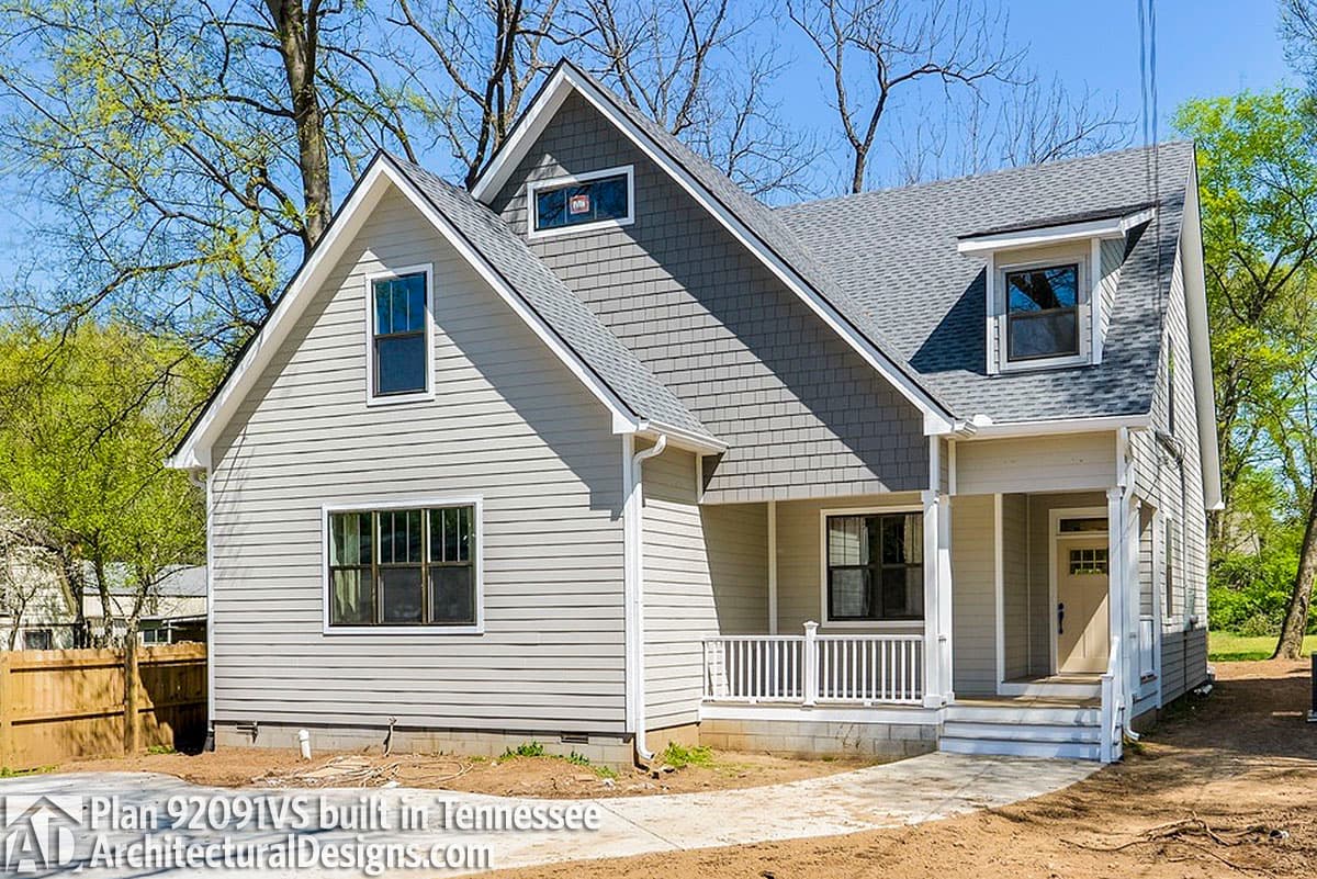 House plan exterior: Two-story home with gabled dormers, a covered front porch, and mixed siding.