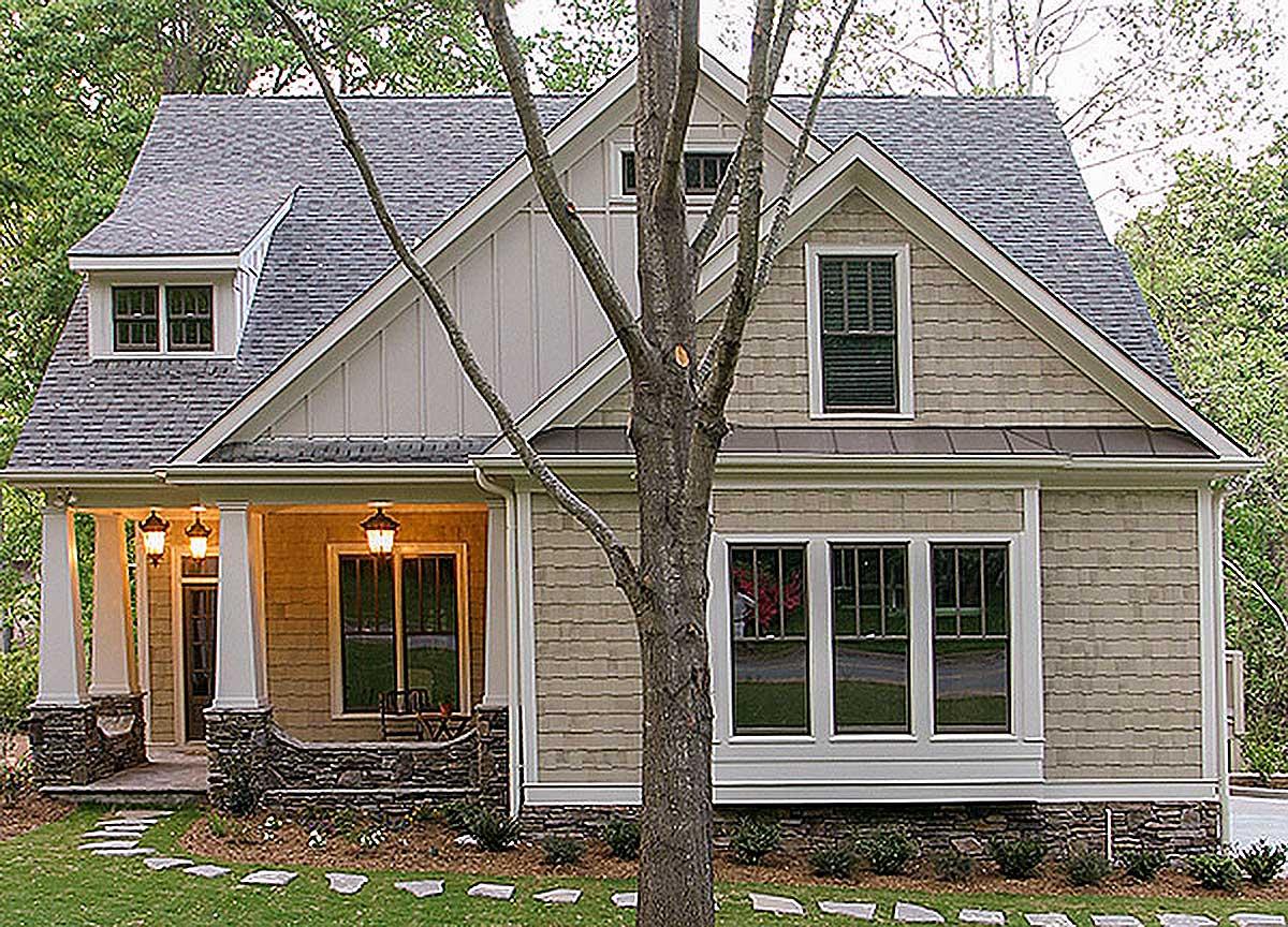 House plan exterior: Two-story Modern Farmhouse with wrap-around porch, dormer window, and stone accents.