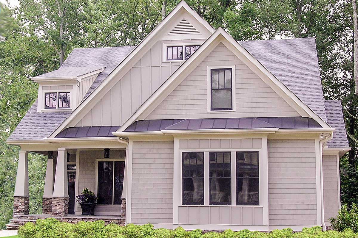 Craftsman style house plan exterior with dormer, gables, stone porch pillars, and multiple window styles.