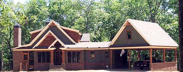 House plan exterior with brick base, multiple gables, exposed rafter tails, covered porch, and attached carport.