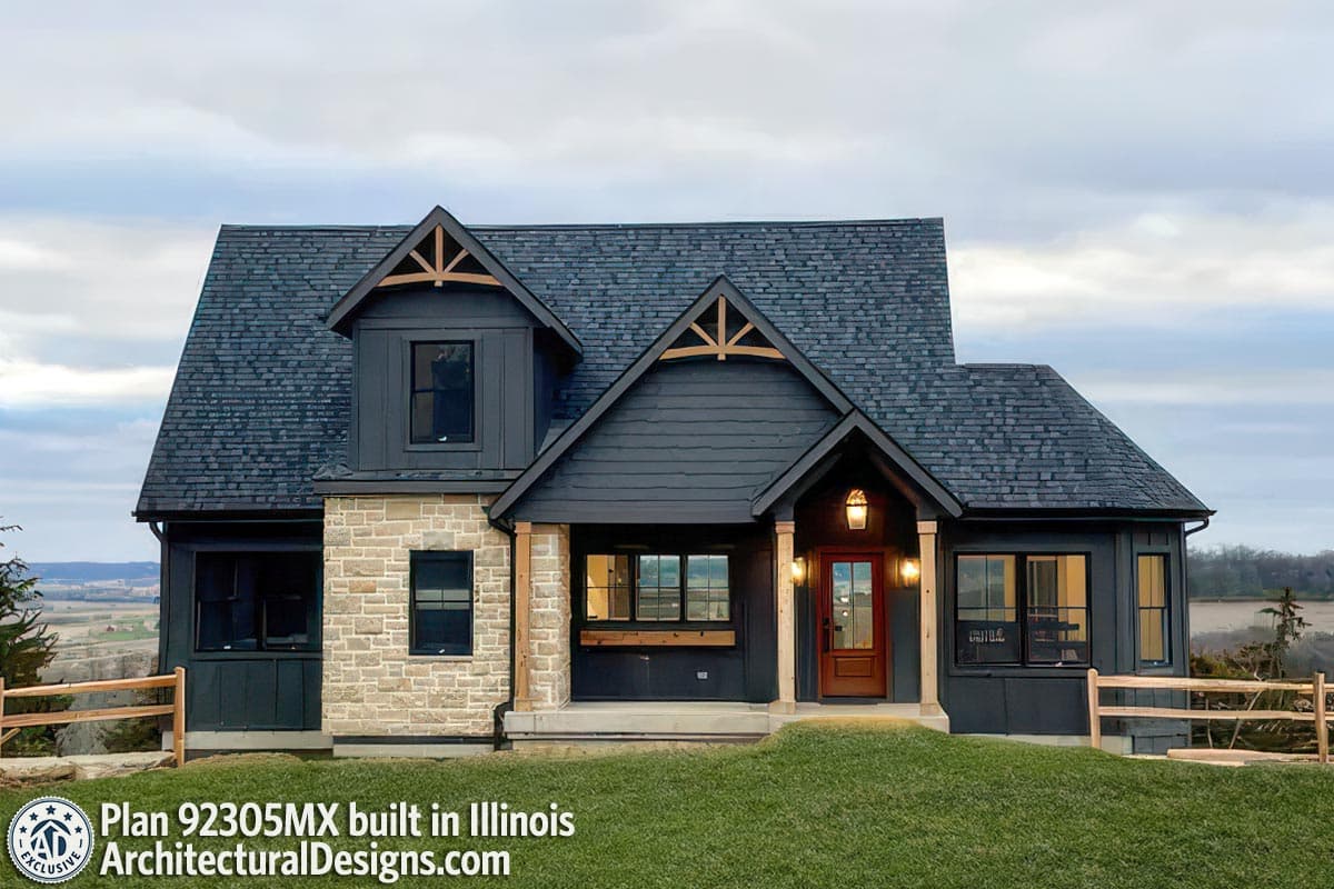 Modern Farmhouse house plan exterior with stone accents, covered entry porch, dormer, and dark roof.