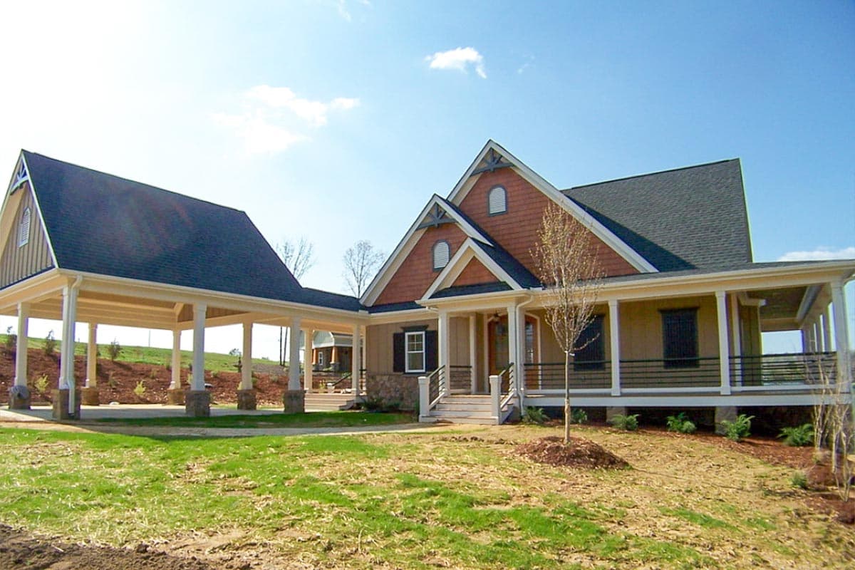 House plan exterior: one-story Modern Farmhouse with wraparound porch, gables, dormers, and attached porte-cochère.