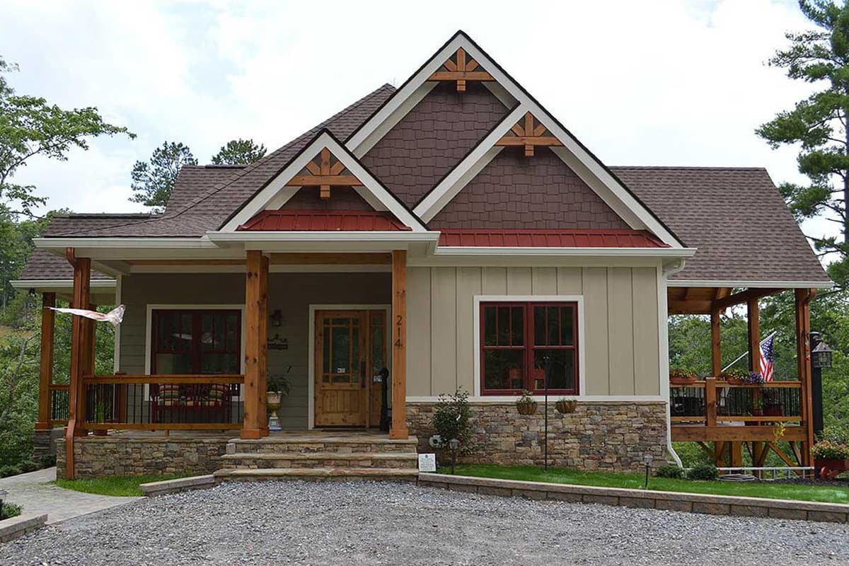 House plan exterior: Craftsman style, one story, with stone base, covered front porch, and prominent gables with wood detailing.