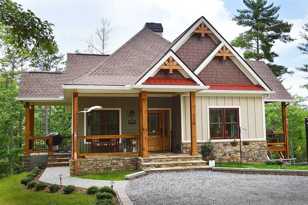 House plan exterior: Traditional style with stone and wood siding, prominent gables, and a wraparound porch.