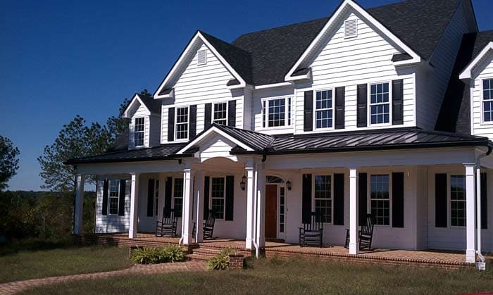 Southern Colonial two-story house plan exterior with wraparound porch, dormers, and white siding.