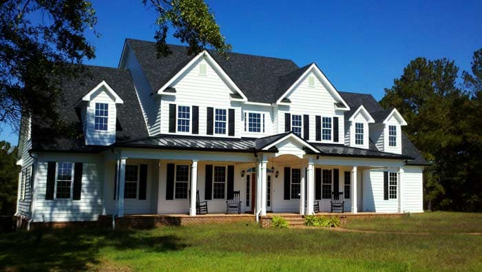 House plan exterior: two-story Modern Farmhouse with wraparound porch, multiple gables, and dormer windows.