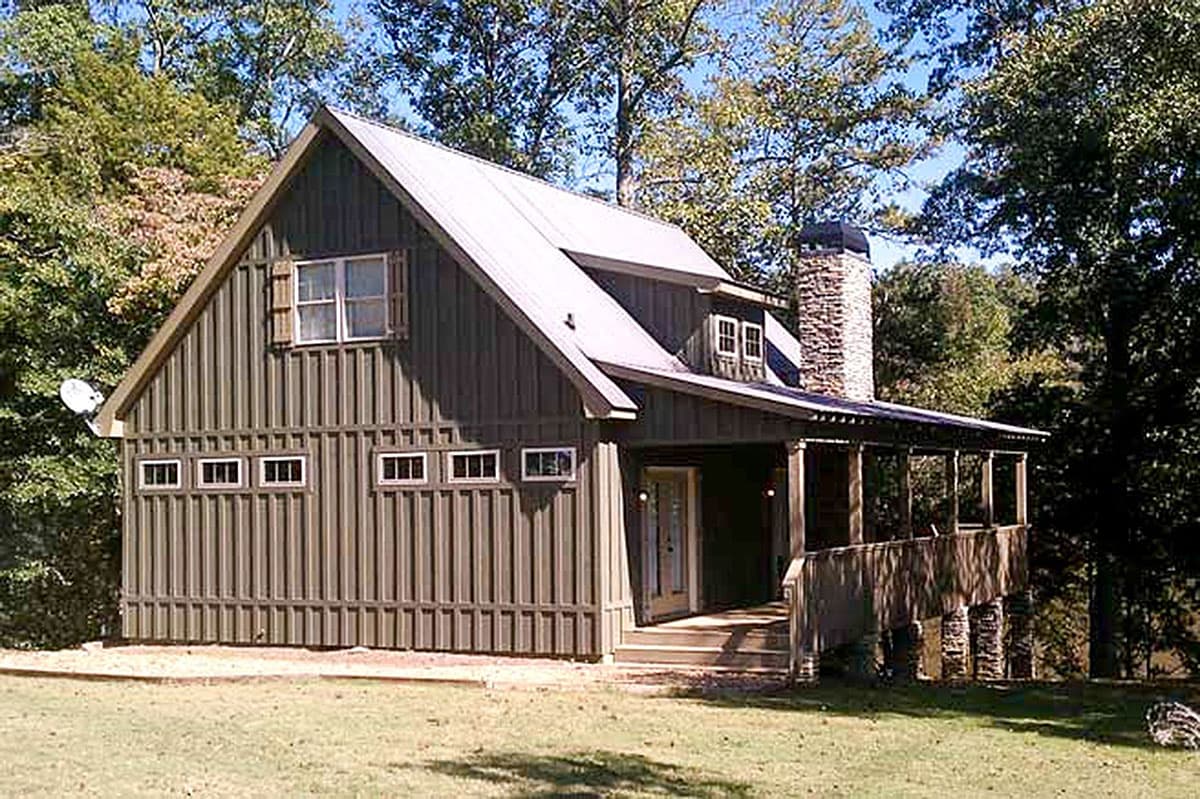 House plan exterior: A two-story home with vertical siding, metal roof, stone chimney, and a wrap-around porch.