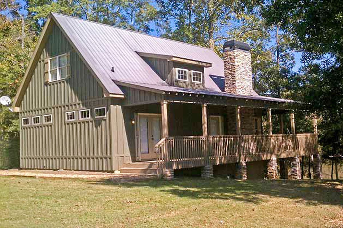 House plan exterior of a two-story cabin with a metal roof, gables, dormer, stone chimney, and wraparound porch.