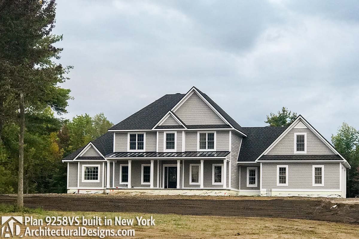 House plan exterior, two-story Modern Farmhouse with a prominent gabled front, a covered porch, and multiple dormers.