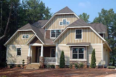 House plan exterior shows a two-story home with a covered front porch, multiple gables, and vertical siding.