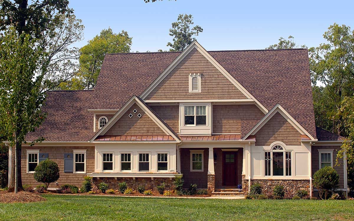 House plan exterior with gables, dormers, shingle siding, stone accents, and a covered entry porch.