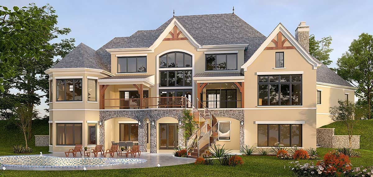 House plan exterior: Multi-story home with stone base, multiple gables, arched and large windows, and a covered balcony.