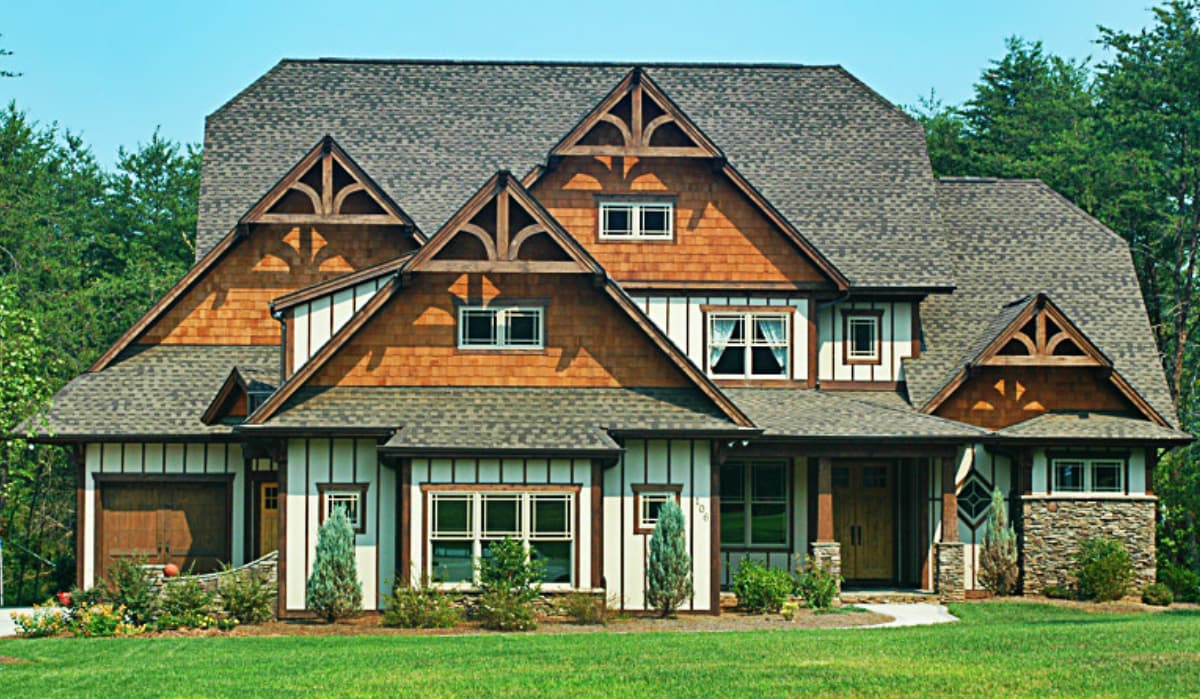 Craftsman house plan exterior with multiple gables, stone accents, a covered porch, and a two-car garage.
