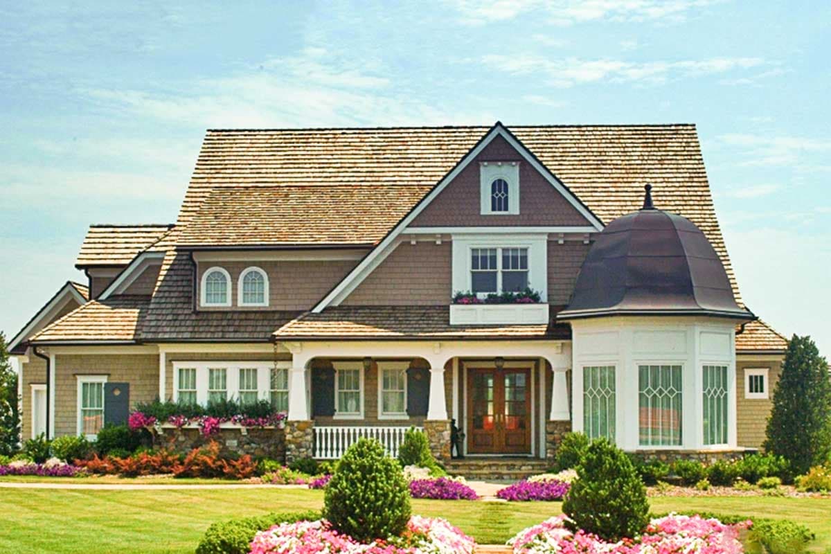 House plan exterior: Craftsman style, 2 stories, hip roof, arched dormers, porch with columns, and bay window with domed roof.