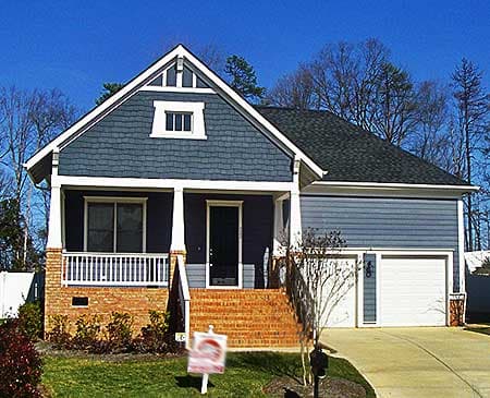 House plan exterior: two-story Modern Farmhouse with front porch, brick accents, gable dormer, and side-entry garage.
