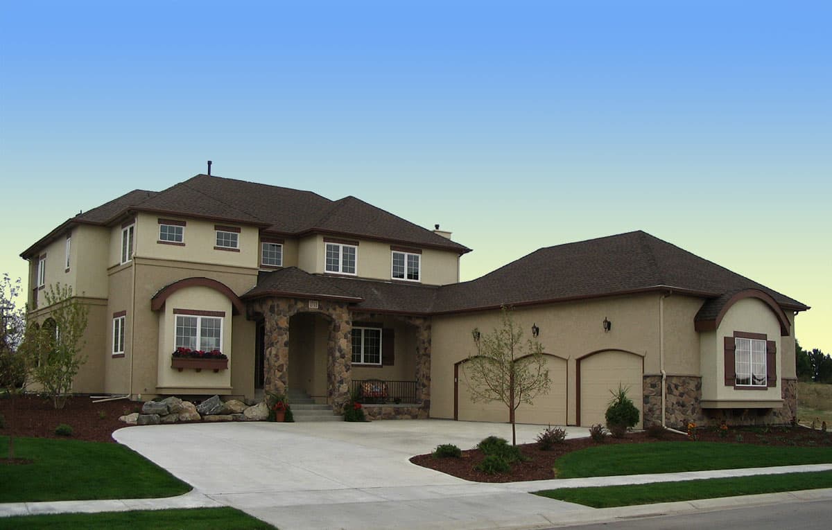 Exterior of a two-story house plan featuring a stone-accented arched entryway, multiple gables, and a three-car garage.