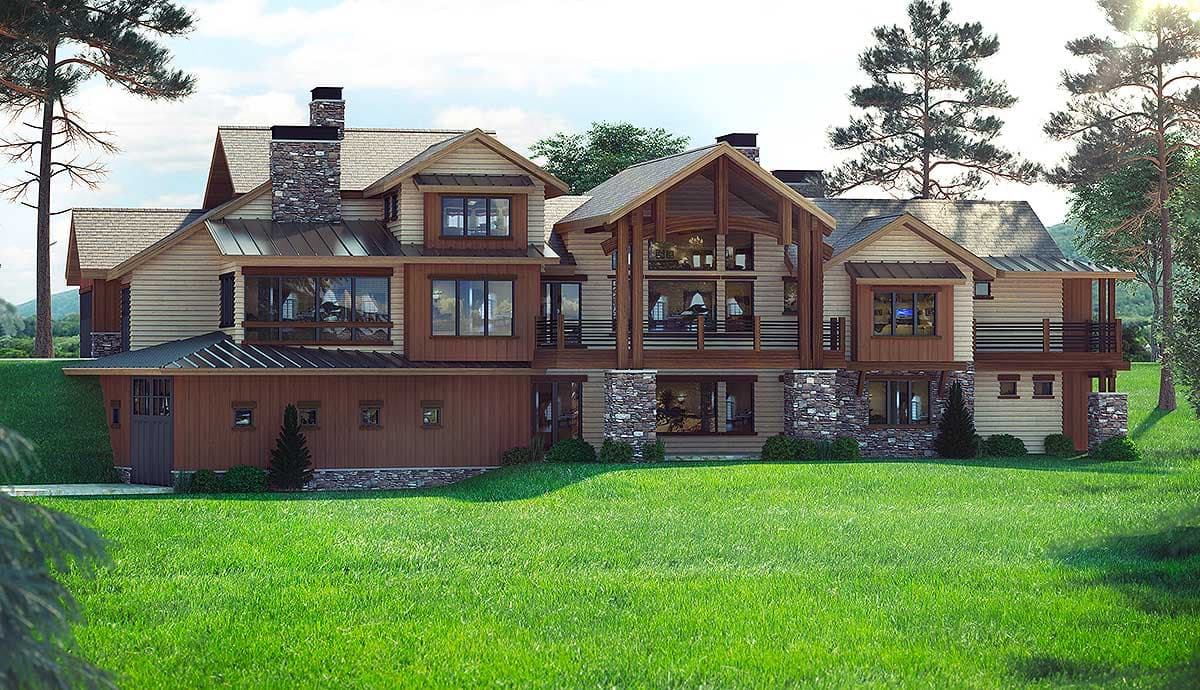 House plan exterior: A multi-story home with gable roofs, stone accents, large windows, and a prominent central covered entryway.